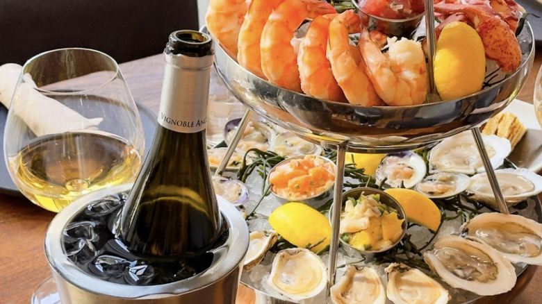 seafood tower with a bottle of white wine