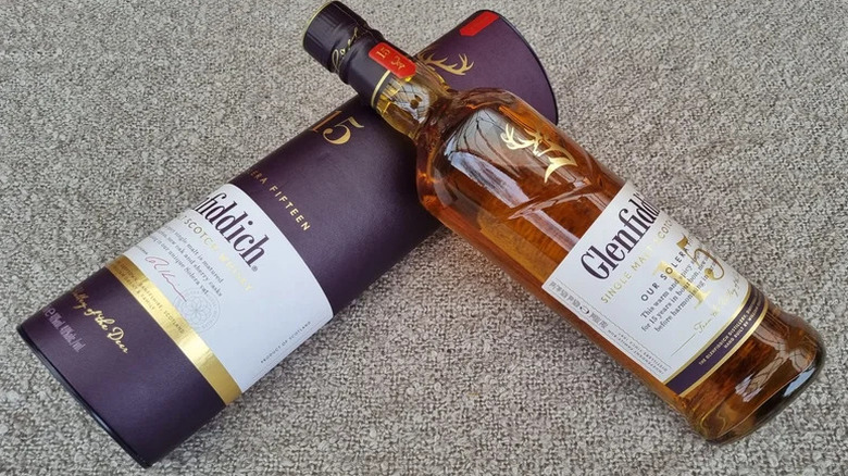 An overhead shot of a bottle of Glenfiddich 15-year resting on its box