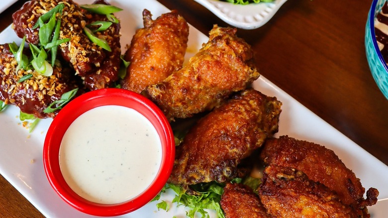 Top view of chicken wings with sauce cup