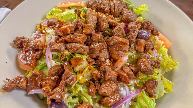 Lamb shawarma salad on white plate