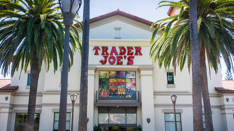 trader joe's storefront behind palm trees
