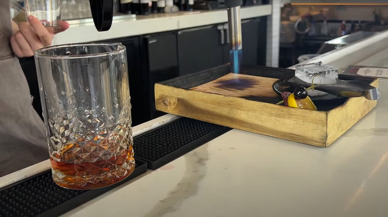 bartender preparing a smoked cocktail