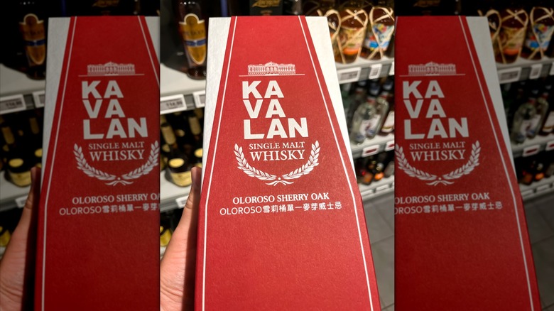 Bottle of Kavalan Sherry Oak Whiskey in red box held in hand
