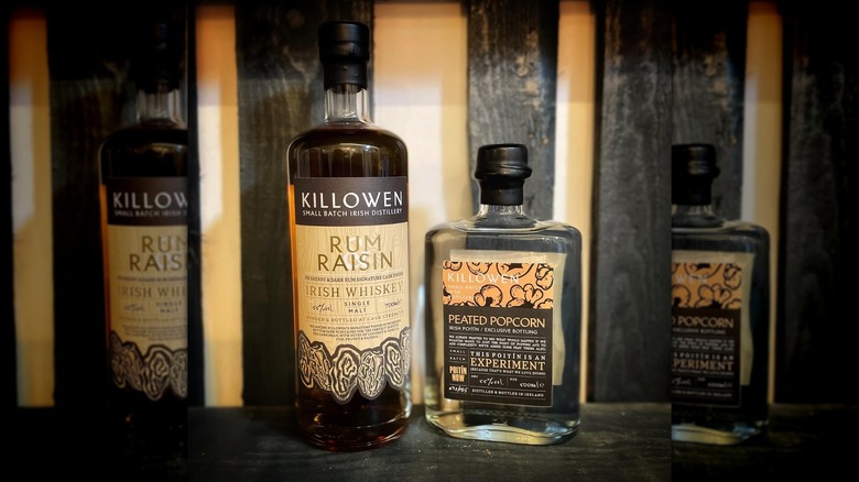 Killowen Rum Raisin and Peated Popcorn bottles on wood surface