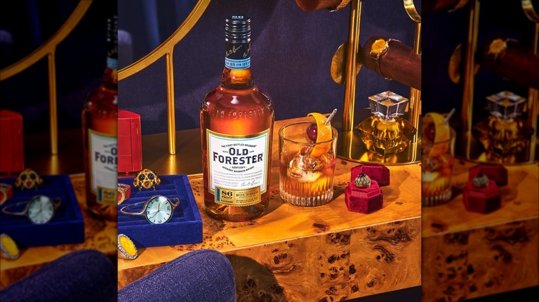 Bottle of Old Forester 86 next to glass of whiskey on ornately decorated counter