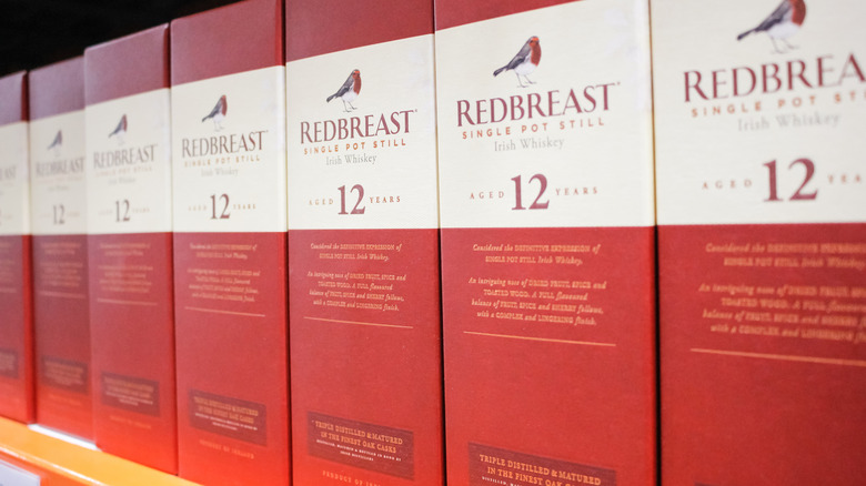 Red boxes of Redbreast 12 Irish Whiskey lined up on shelf