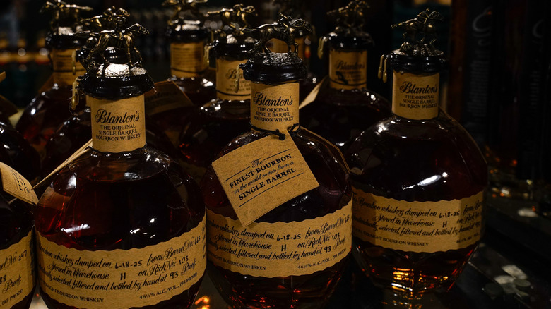 A collection of Blanton's bottles showcased together with their unique toppers