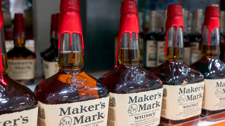 A row of Maker's Mark bottles shown on a shelf