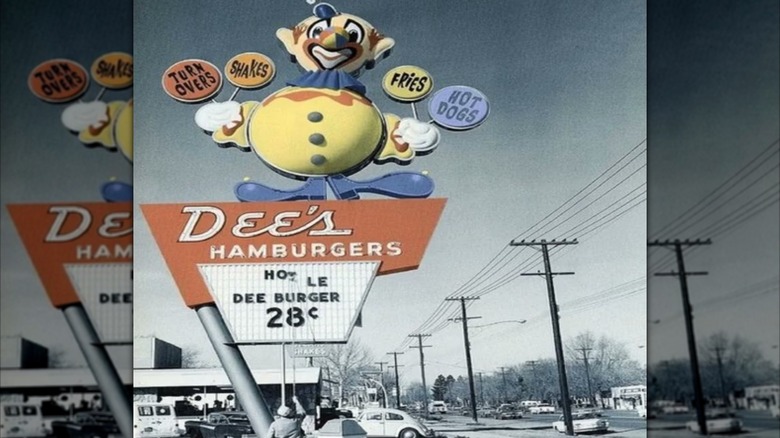 Mirrored image, grainy image of Dee's Hamburgers sign with giant clown