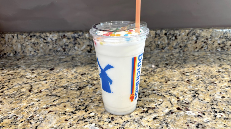 Dutch Bros birthday cake shake on a marble countertop