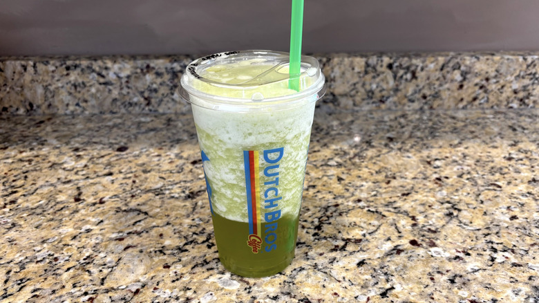 Dutch Bros green apple smoothie on a marble countertop
