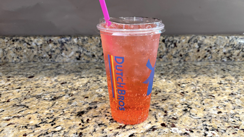 Dutch Bros watermelon sparkling soda on a marble countertop