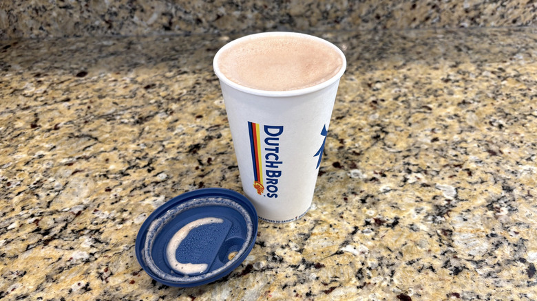 Dutch Bros salted caramel hot cocoa on a marble countertop
