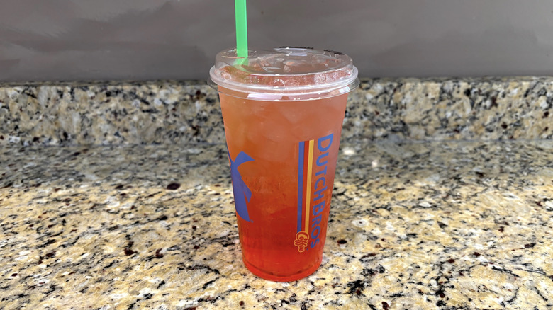 Dutch Bros strawberry lemonade on a marble countertop