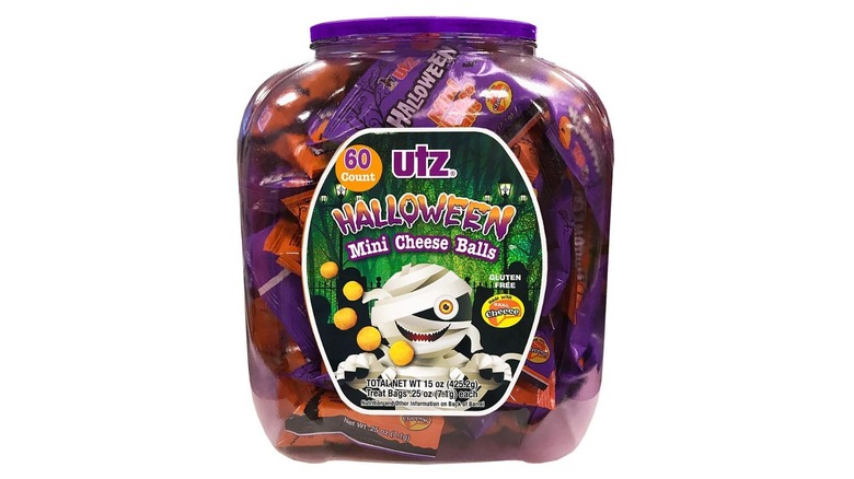 A large plastic tub of individual packs of mini cheese balls for Halloween