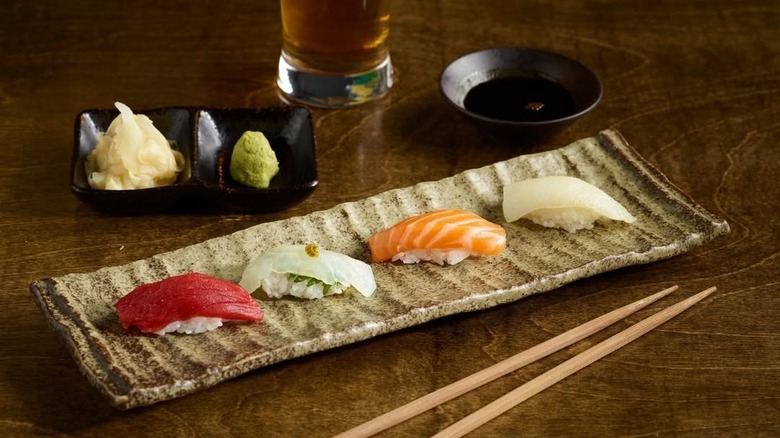 Sushi plate with wasabi, soy sauce, and chopsticks