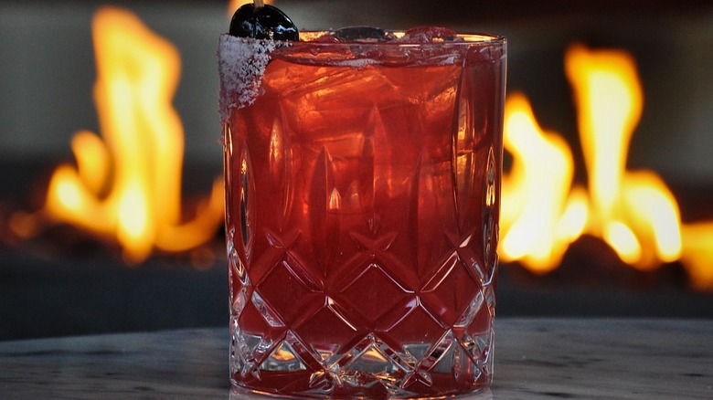 Cocktail with firepit in the background