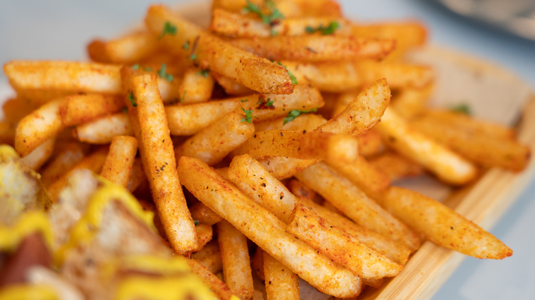 Golden crispy French fries in a pile