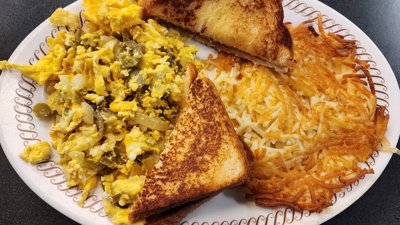 Waffle house hash brown on breakfast plate with eggs