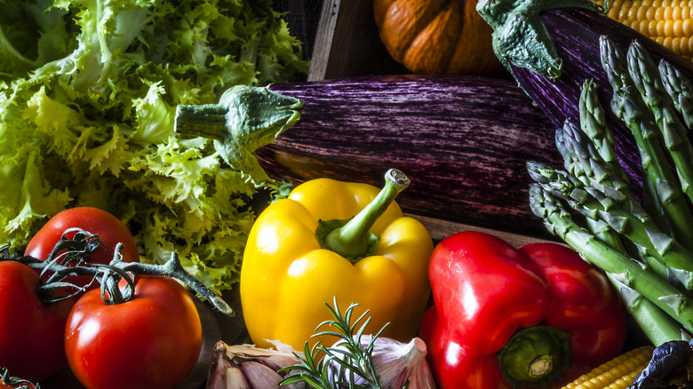 Selection of fresh bell peppers and tomatoes and other produce