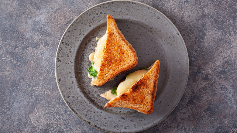 Two French sandwich halves on a concrete background