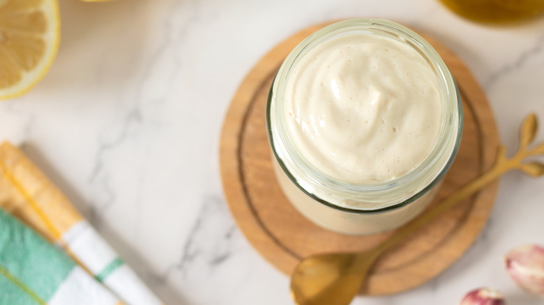 Vegan mayonnaise in a jar on a white table