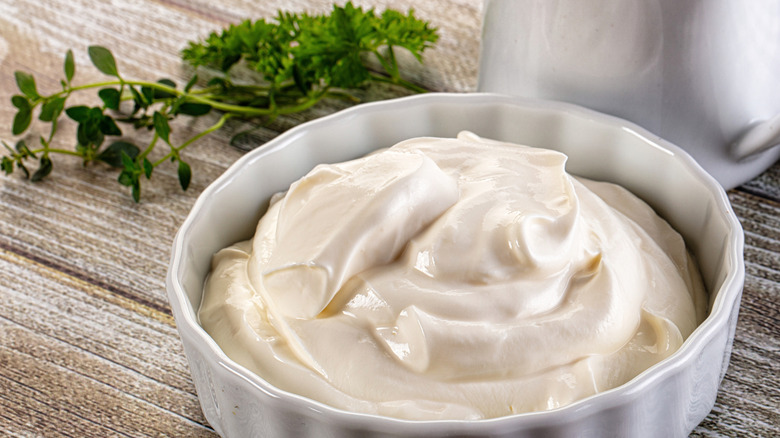 Vegan sour cream at Taco Bell in a white bowl on a wooden table