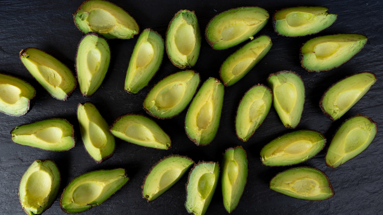 Avocado slices on a black counter