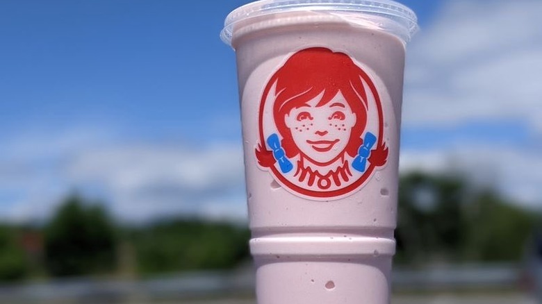 Strawberry frosty with the Wendy's logo on the plastic cup