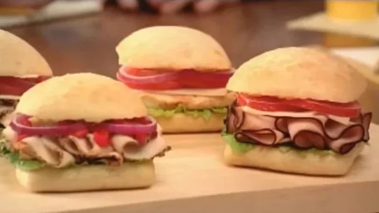 Three Wendy's frescata sandwiches on a wooden table