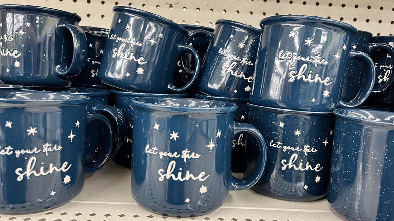 Many blue mugs sitting on a shelf