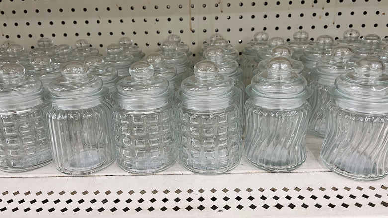 Glass jars with lids on a shelf