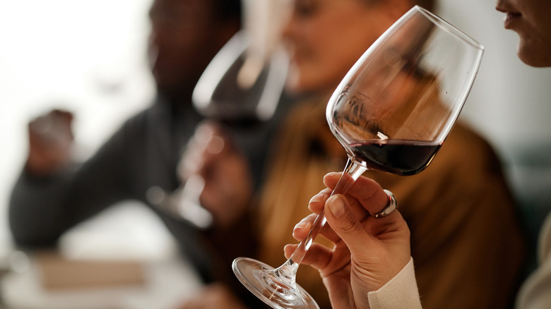 people drinking red wine