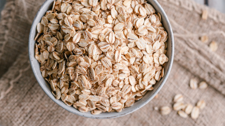 A bowl of dry, uncooked rolled oats