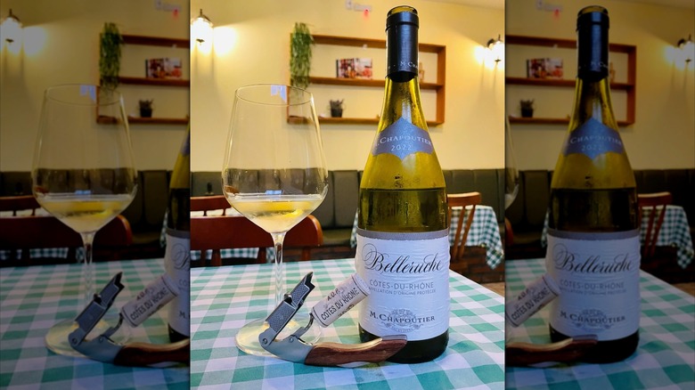 a bottle and glass of M. Chapoutier Côtes du Rhône Belleruche Blanc white wine