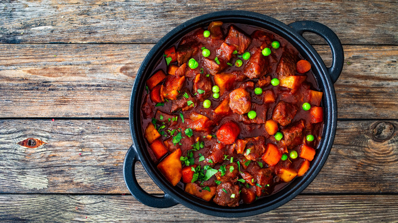 A black pot of Irish stew on a table