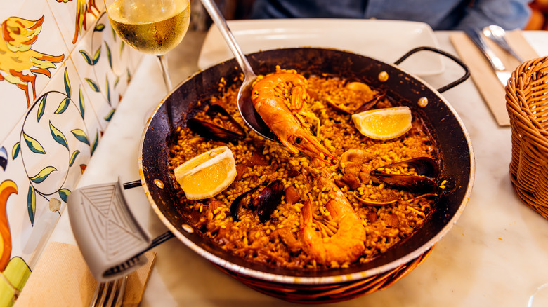 A pan of seafood paella on a restaurant table