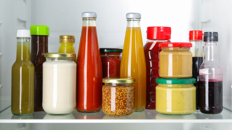 Refrigerator shelf full of condiments