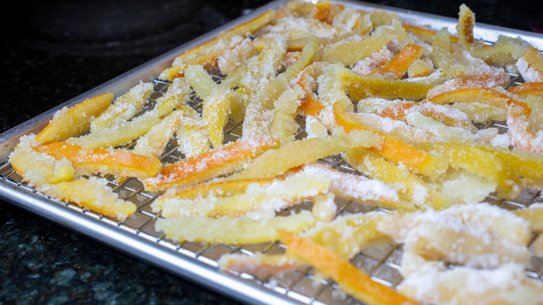 Candied lemon and orange peels on wire cooling rack