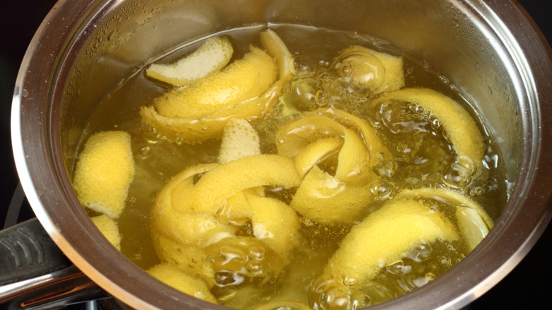 Lemon peels simmering in pot of water