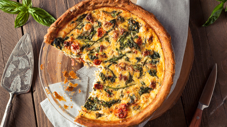 Sliced vegetable quiche on serving plate