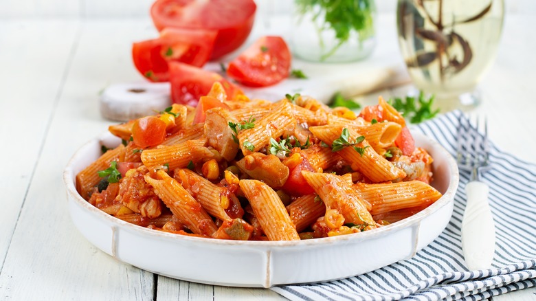 Plate of penne pasta with tomato and veg sauce