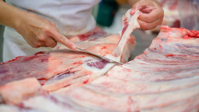 side of beef being trimmed