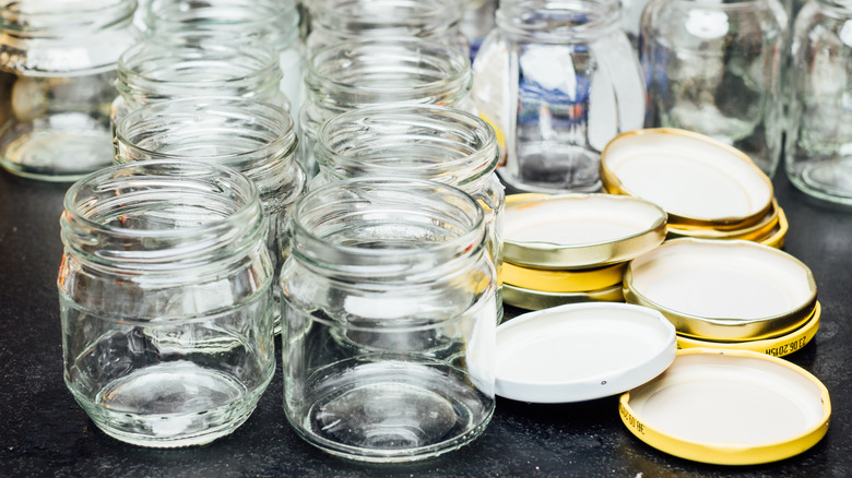 empty glass jars and pile of lids