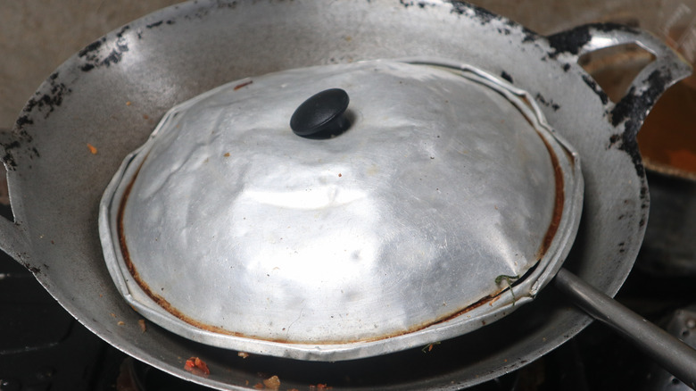 frying pan with bent metal lid