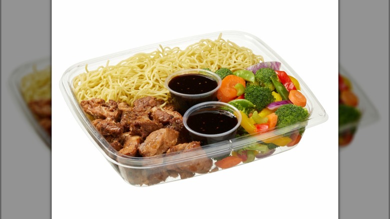 Open container of Kirkland Signature Yakisoba Stir Fry on white background.