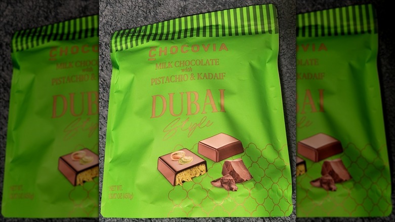A green bag of Chocovia Milk Chocolate with Pistachio & Kadaif Dubai-Style on a table