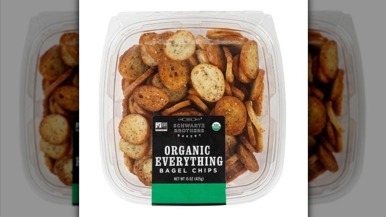 Plastic container of Schwartz Brothers Bakery Organic Everything Bagel Chips on a white background