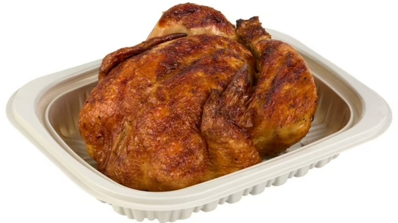A Member's Mark Rotisserie Chicken in a plastic deli container on a white background