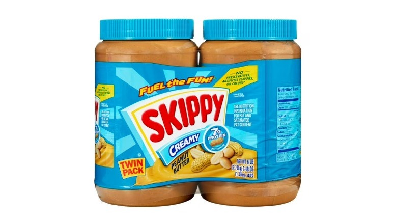 Two jars of Skippy Creamy Peanut Butter on a white background